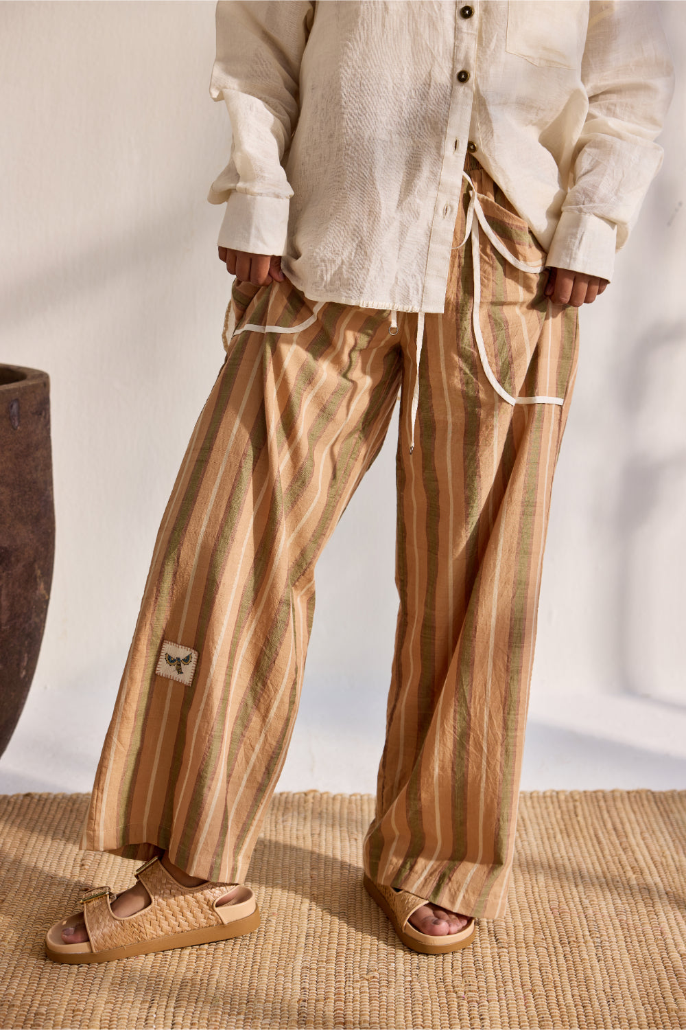 Beige woven stripe pants with applique